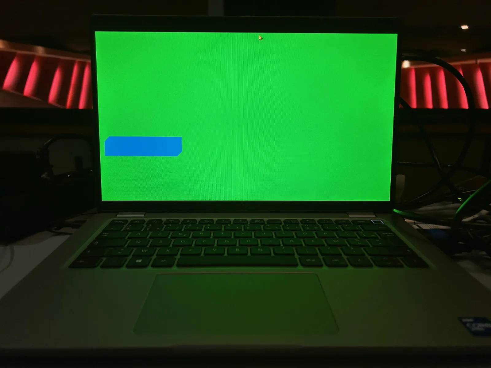 Laptop whose screen shows a plain green background with a blue rectangle