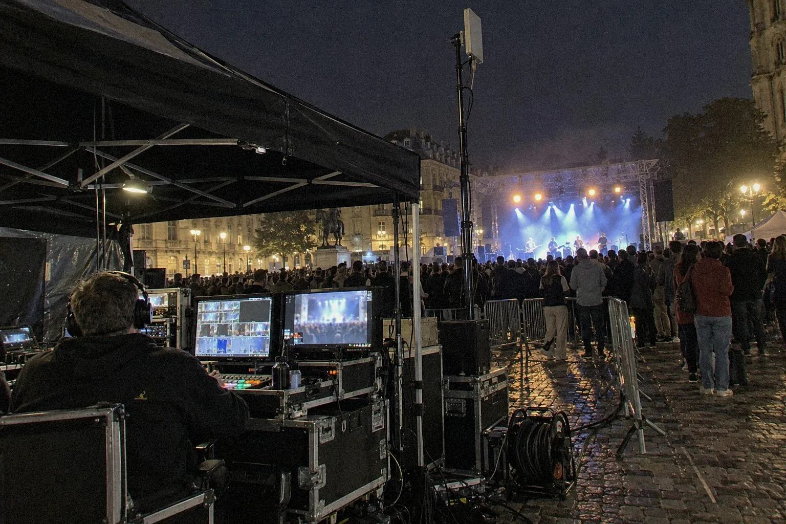 Broadcast control under a tent and a link antenna at the edge of a night-time event