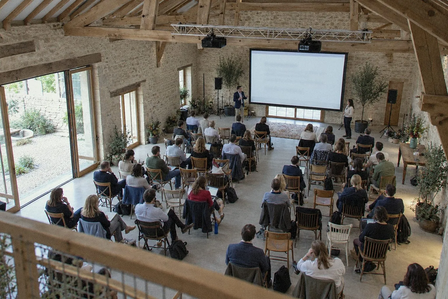 Seminar plenary in a renovated barn, seen from the mezzanine