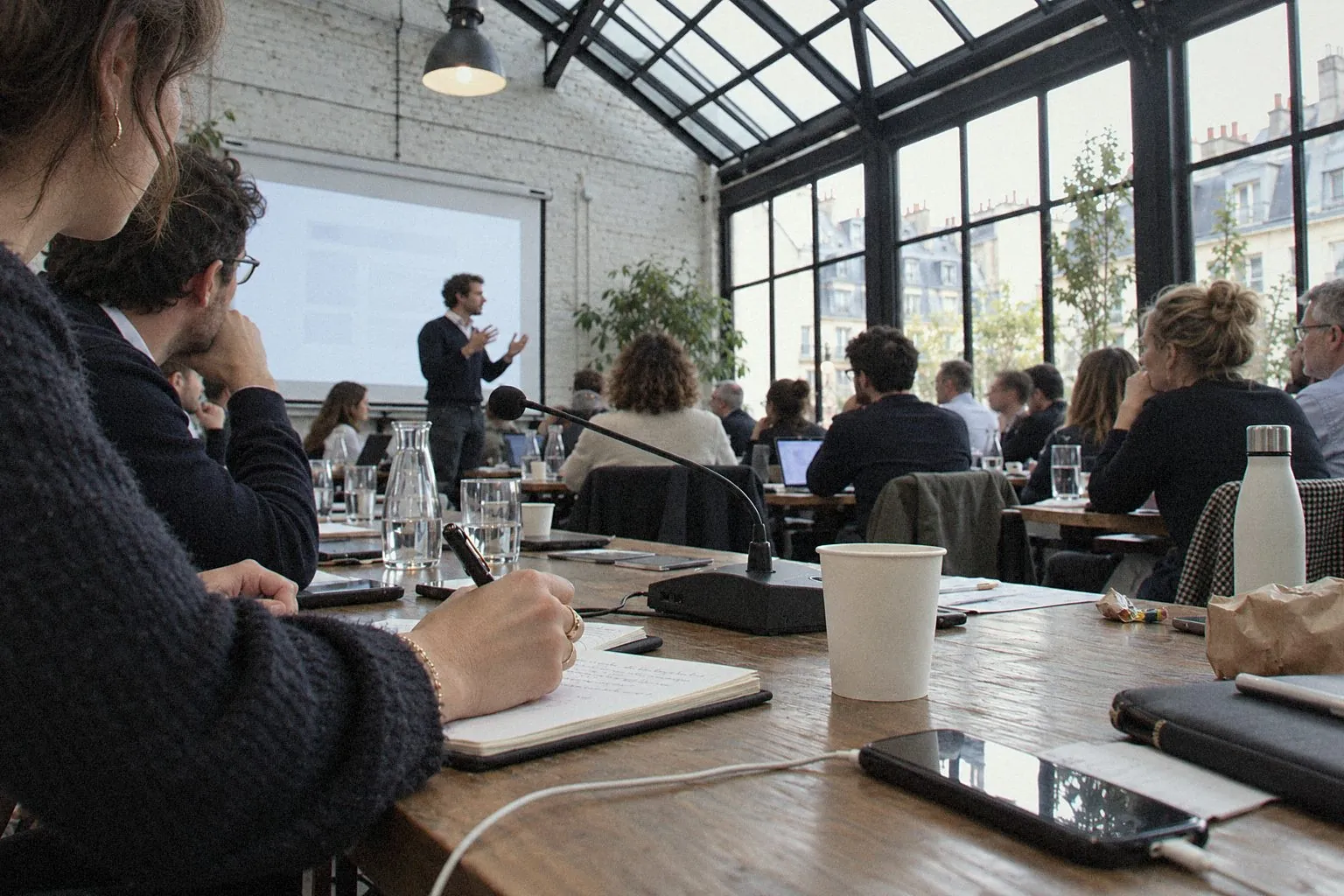 Training session in a loft with a glass roof, table microphone in the foreground