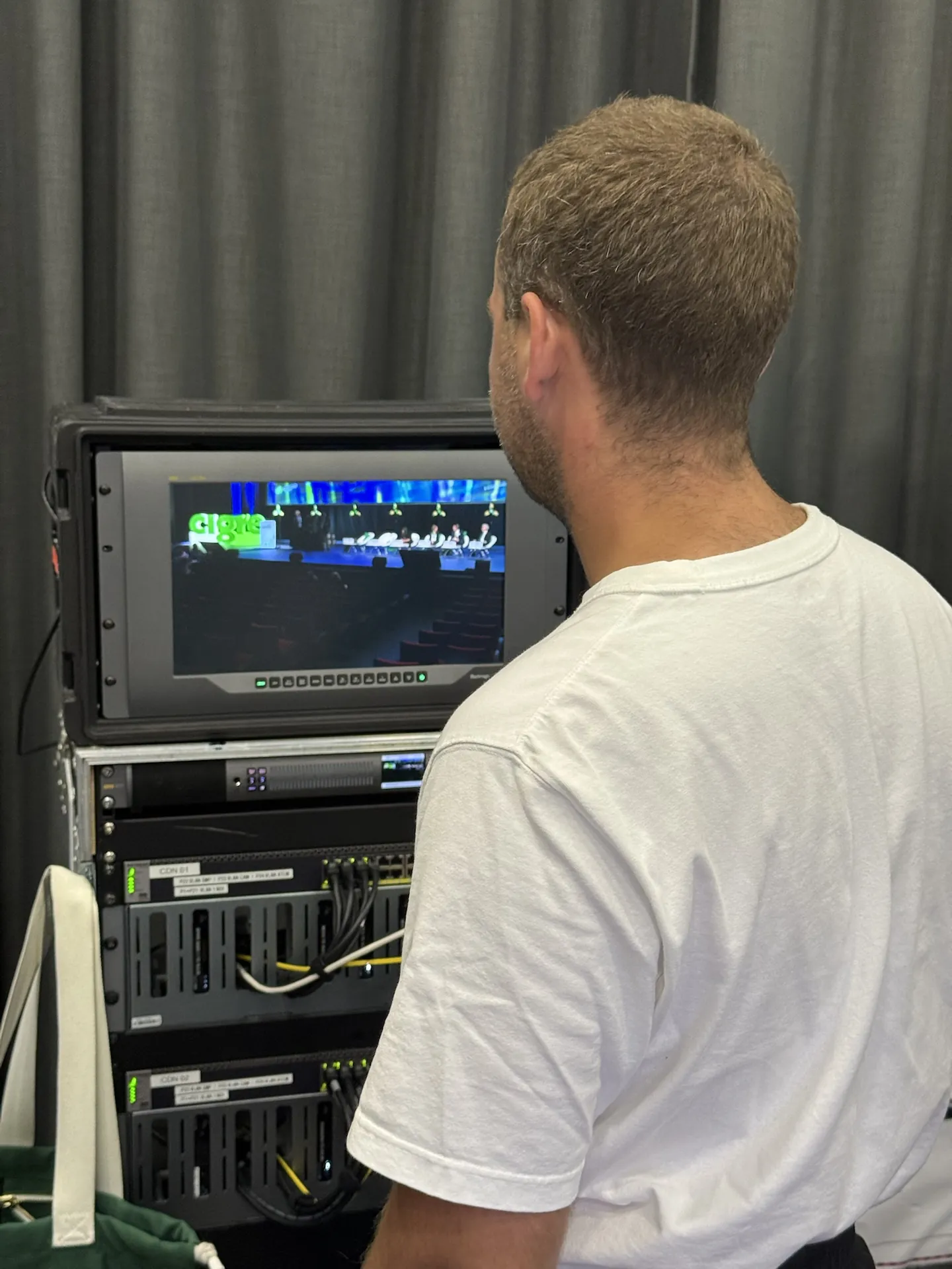 Technician checking the signal on the rack monitor